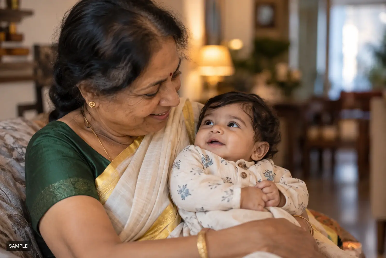 Parent holding a baby at a birthday party