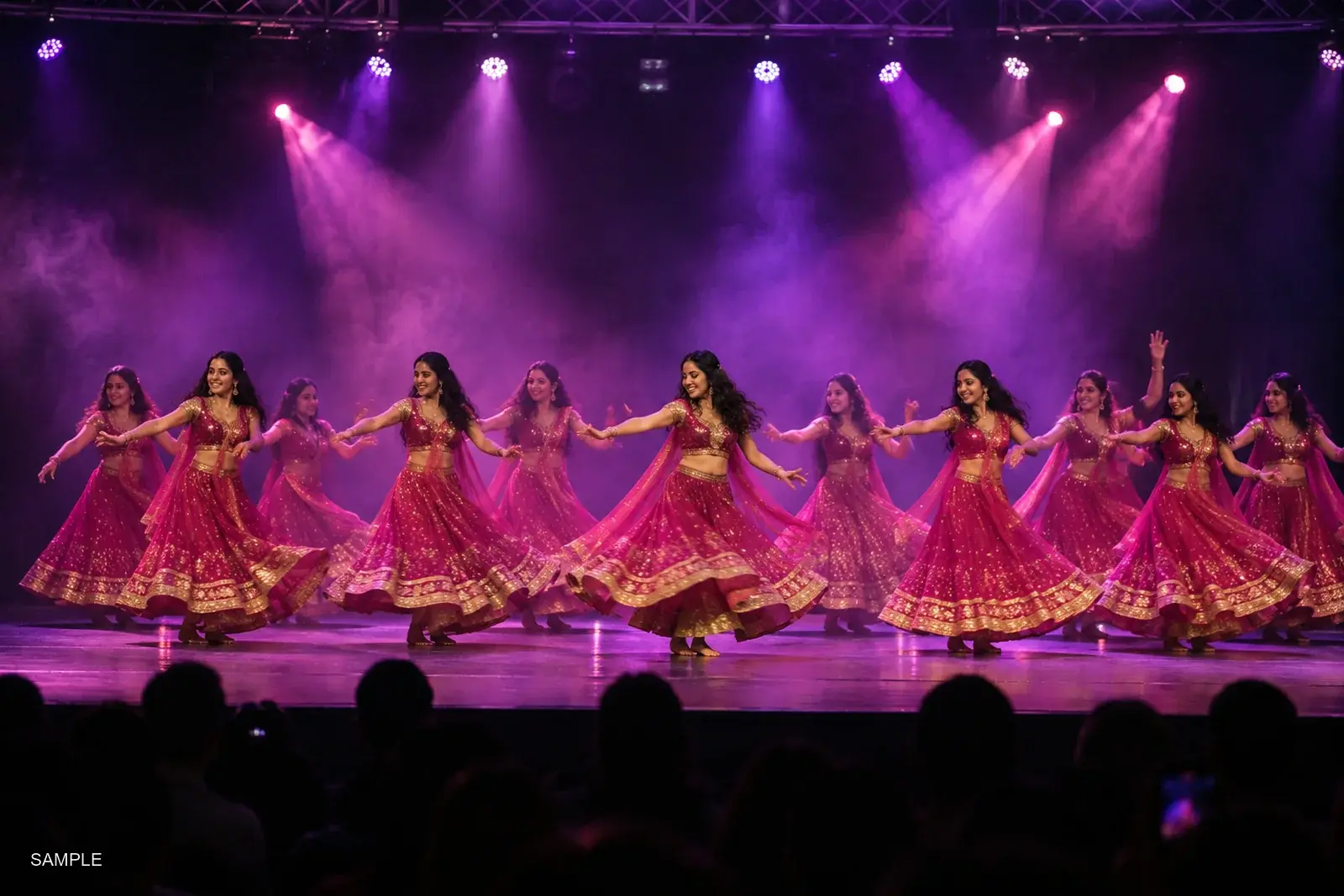 Dance studio troupe performing a group number under coloured stage lights